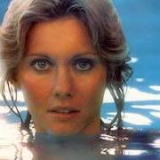 Il testo WRAP ME IN YOUR ARMS di OLIVIA NEWTON-JOHN è presente anche nell'album Come on over (1976)